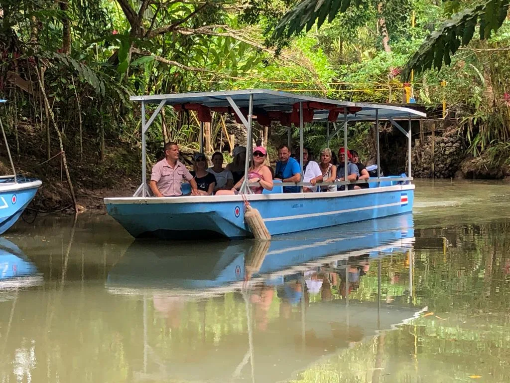 Tour group watching monkeys from the boat on a Damas Island monkey tour near Manuel Antonio